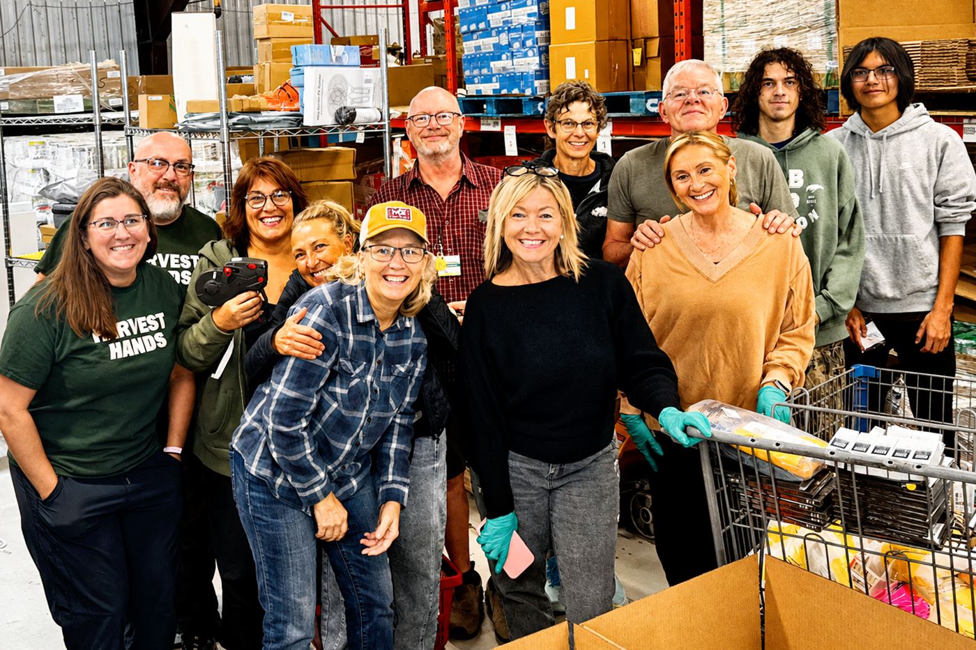 Harvest Hands volunteers and staff gathered in the warehouse
