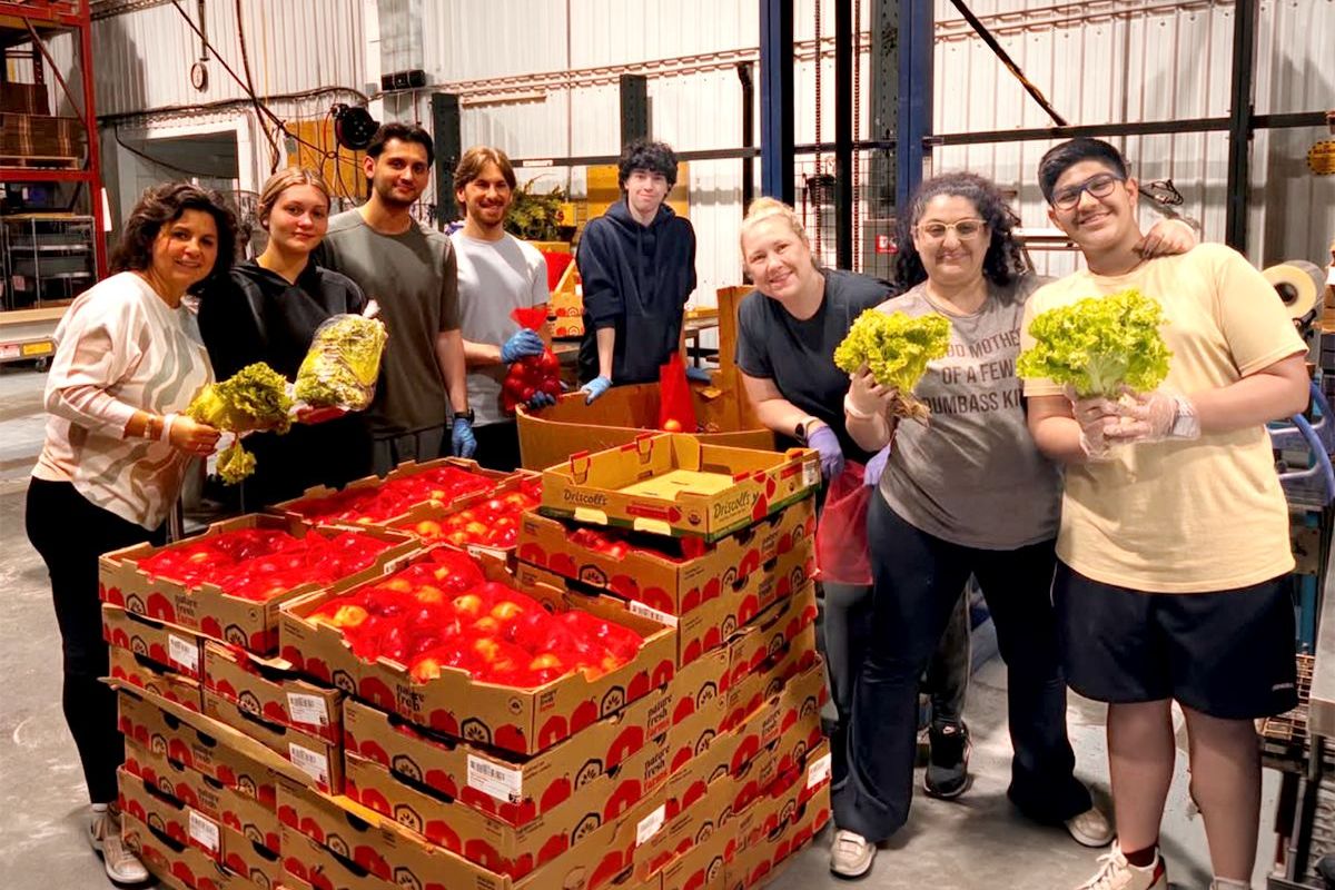 Harvest Hands volunteers with skids of rescued produce in the warehouse